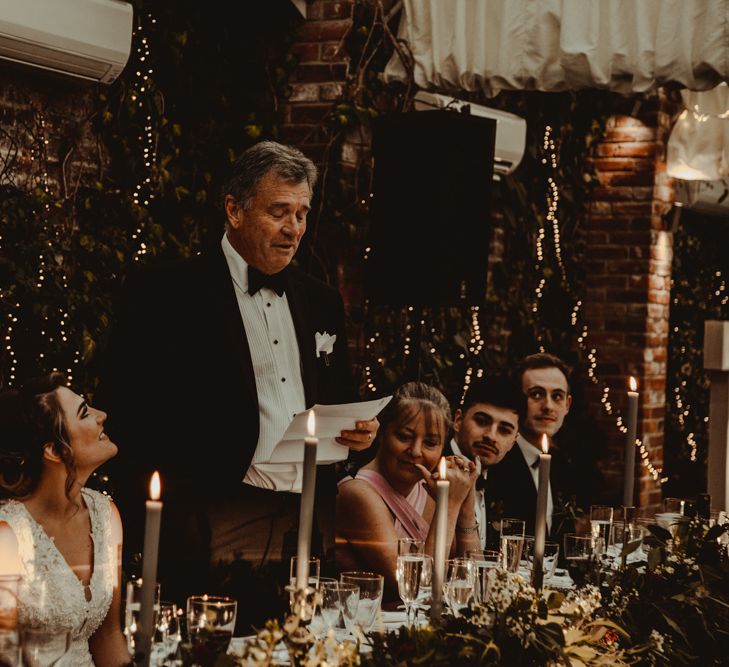 Father of the Bride Wedding Speech at the Top Table Covered in Greenery, Candles and Fairy Lights Wedding Decor