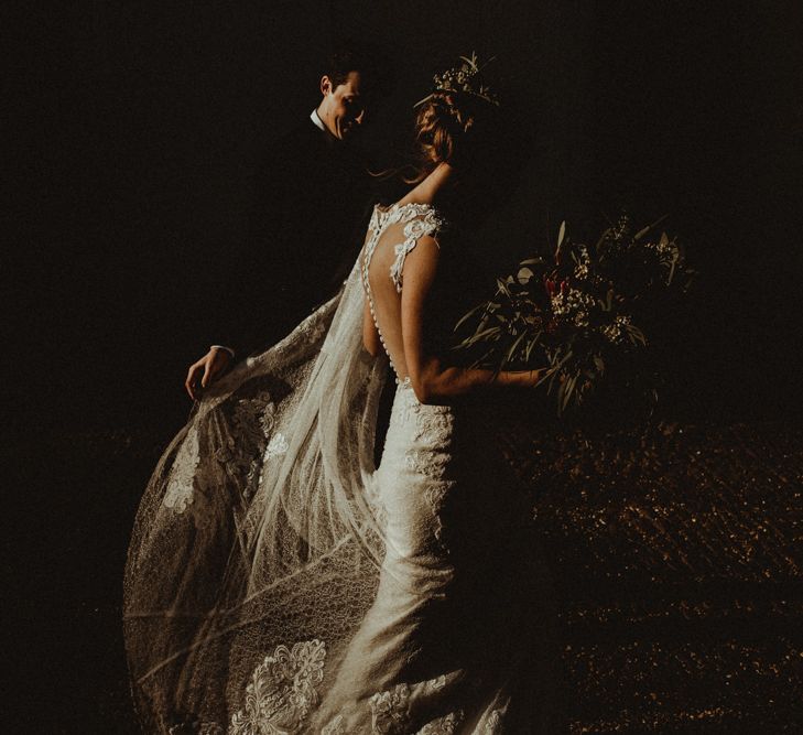 Bride in Lace Wedding Dress and Groom in Black Tie Suit Walking