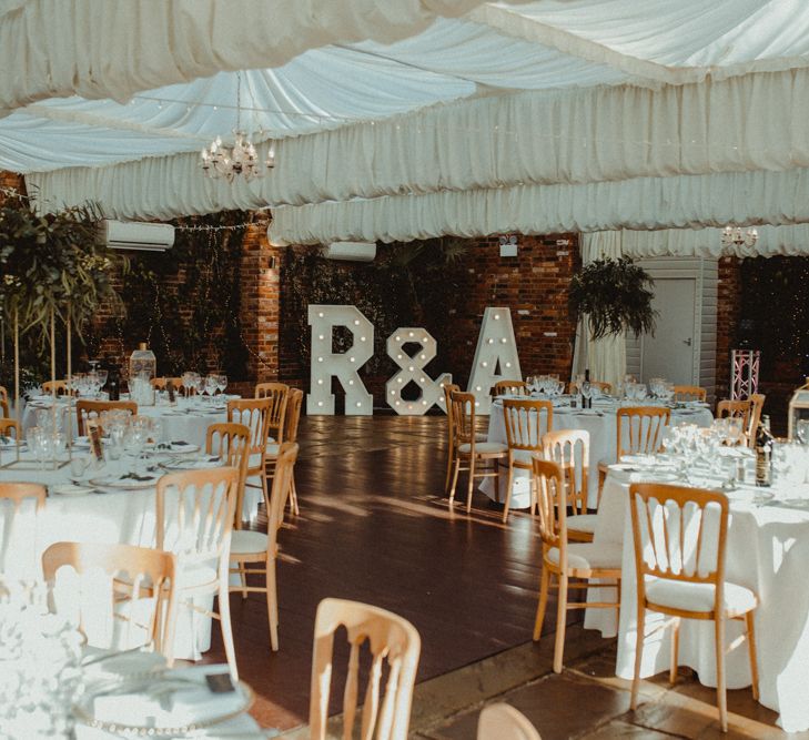 Wedding Reception Decor at Northbrook Park Wedding Venue with Giant Light Up Letters and Tall Foliage Displays