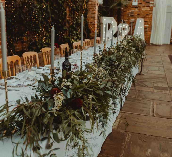 Top Table Foliage and Taper Candle Wedding Decor