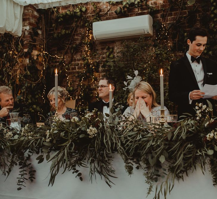 Grooms Wedding Speech at the Top Table with Foliage and Taper Candle Wedding Decor