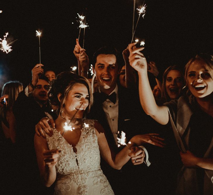 Sparkler Moment with Bride in Lace Wedding Dress and Groom in Tuxedo