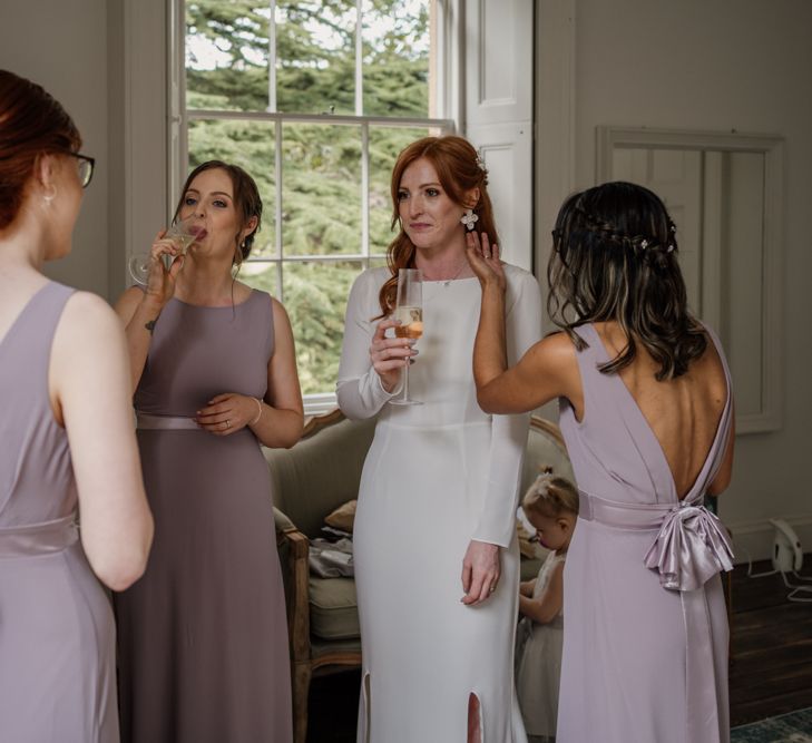 Bridal party on wedding morning sipping champagne