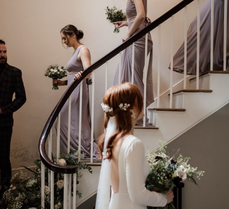 Bridal party walking down the stairs at Aswarby Rectory