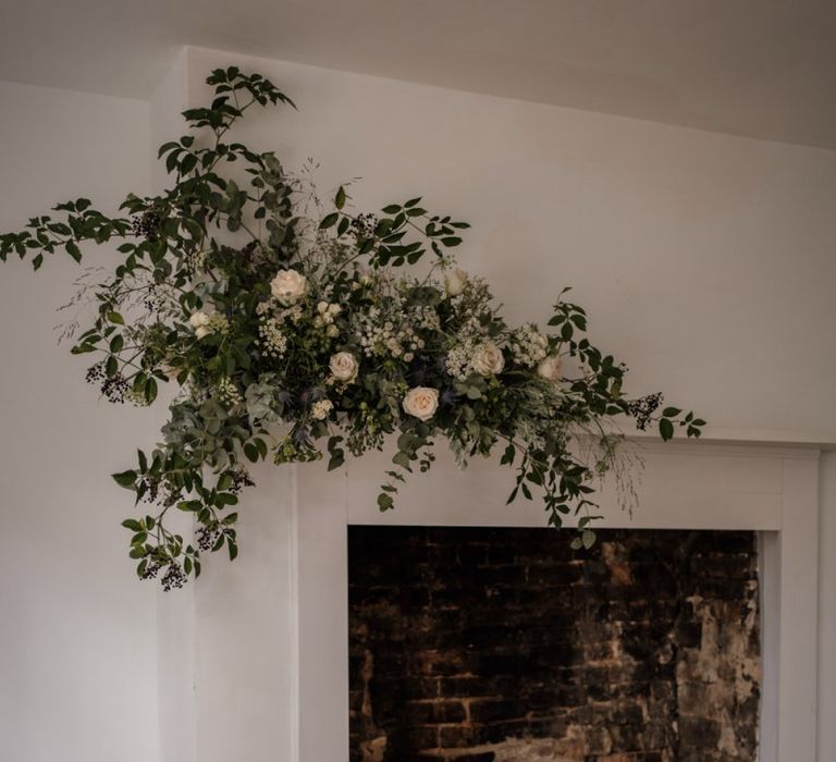 Fireplace at Aswarby Rectory decorated in white and green flowers