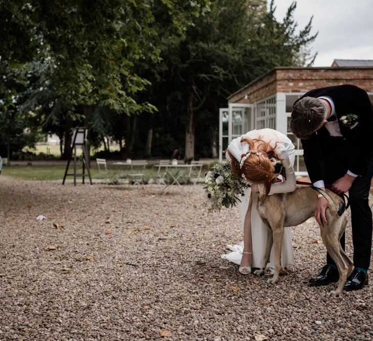 Bride and groom with their pet dog at Aswarby Rectory