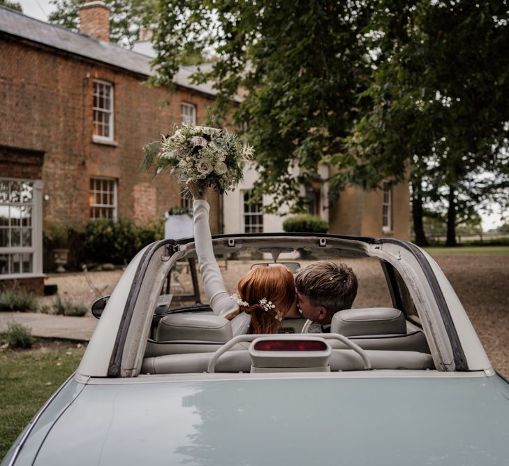 Bride and groom in wedding car at Aswarby Rectory