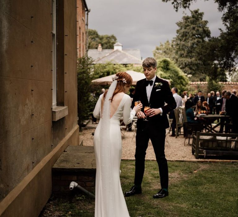 Bride in minimalist Alexandra Grecco with backless detail