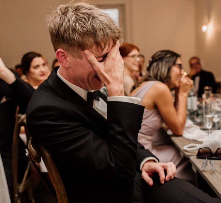 Wedding guests laughing during wedding speeches