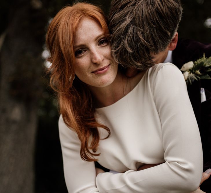 Beautiful bride with red hair and freckles in long sleeve Alexandra Grecco wedding dress