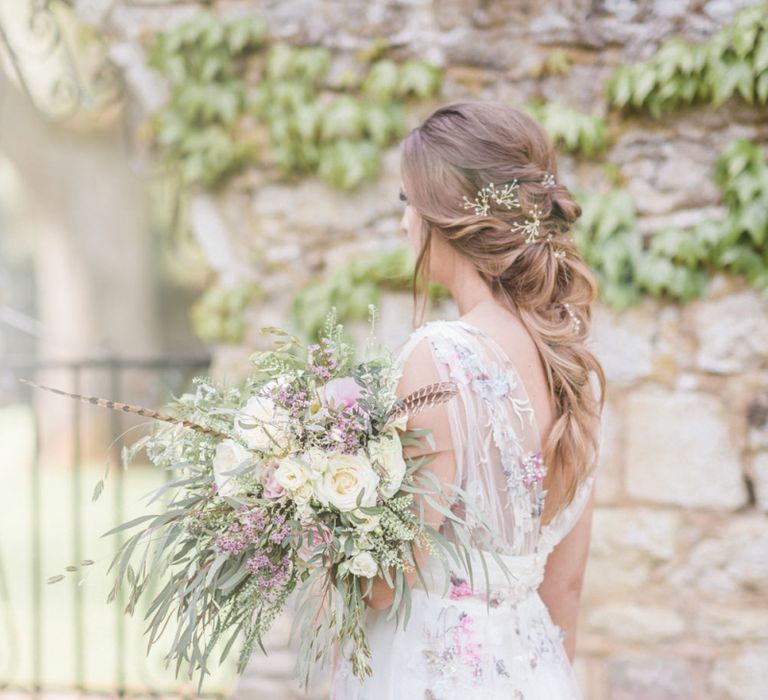 Bride in Stephanie Allin Floral Wedding Dress Holding Romantic White and Lilac Wedding Bouquet with Foliage