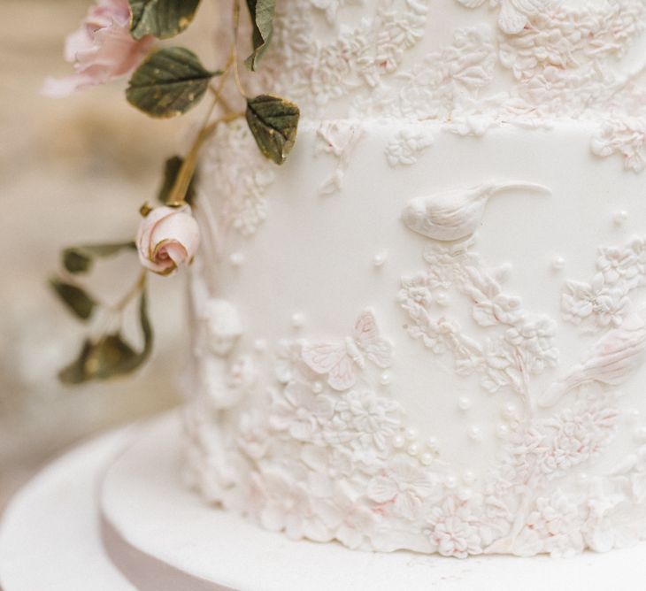 Elegant White Wedding Cake with Floral Decor by Gifted Heart Cakes