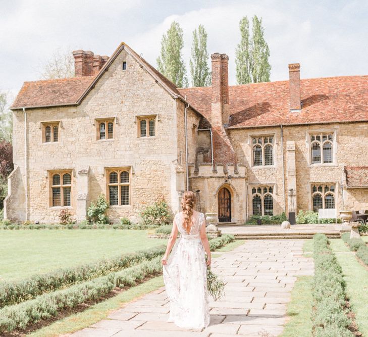 Bride in Floral Wedding Dress Walking Through Notley Abbey Country Gardens