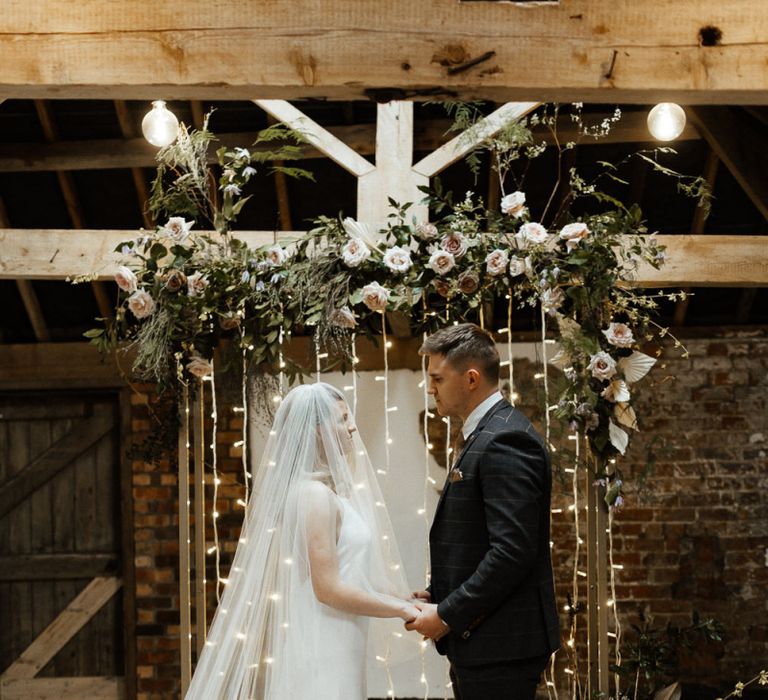 Bride and Groom at the Fairy Light Altar Exchanging Vows