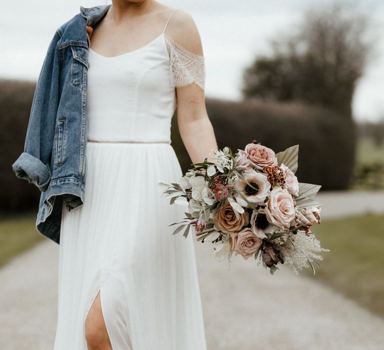 Bride in Spaghetti Strap Wedding Dress with Front Split, Boots and Denim Jacket