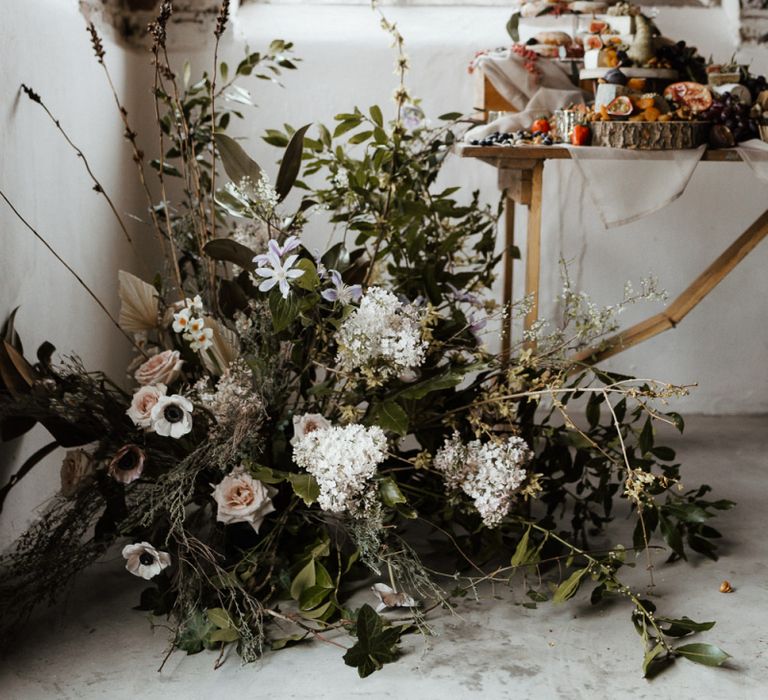 Floral Arrangement Decorating the Foot of the Dessert Table