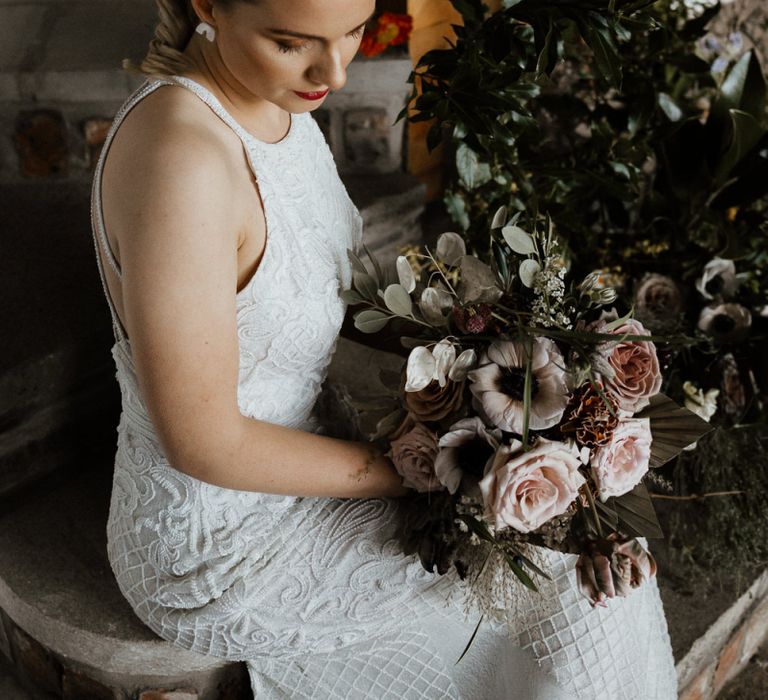 Bride in Halterneck Beaded Wedding Dress with Bridal Bouquet