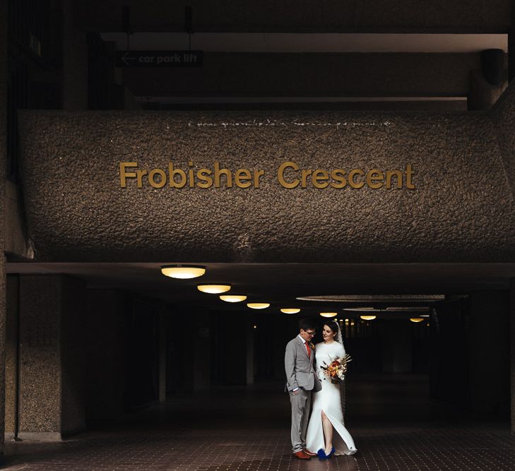 Bride in Charlie Brear Wedding Dress and Groom in Light Grey Suit with Orange Tie