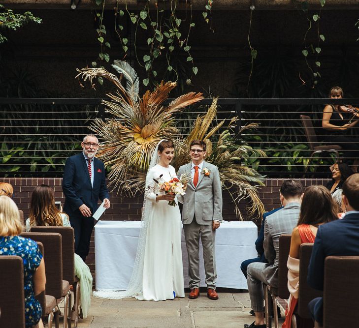 Wedding Ceremony with Bride in Charlie Brear Dress and Groom in Grey Suit