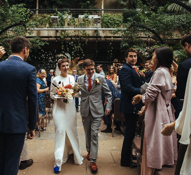 Confetti Moment with Bride and Groom Walking Up the Aisle