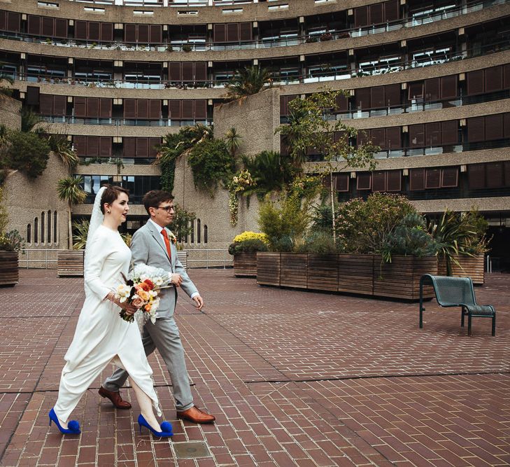 Bride in Charlie Brear Wedding Dress and Electric Blue Pom Pom Shoes and Groom in Light Grey Suit