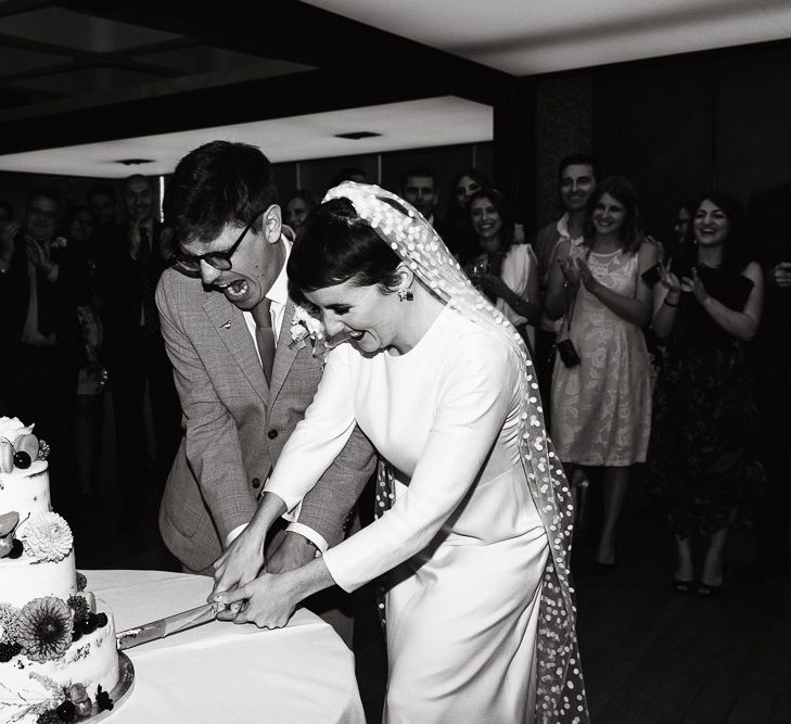 Bride and Groom Cutting the Wedding Cake