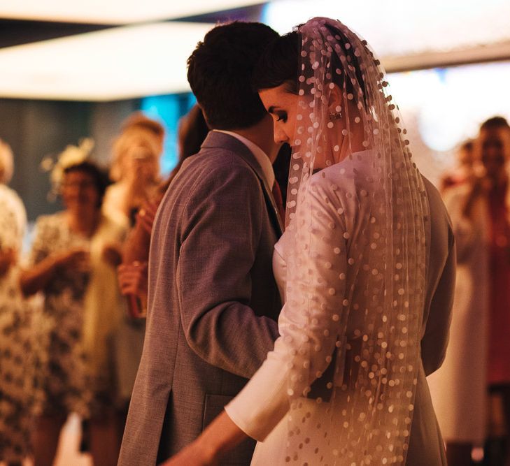 First Dance with Bride in Minimalist Wedding Dress and Polka Dot Veil