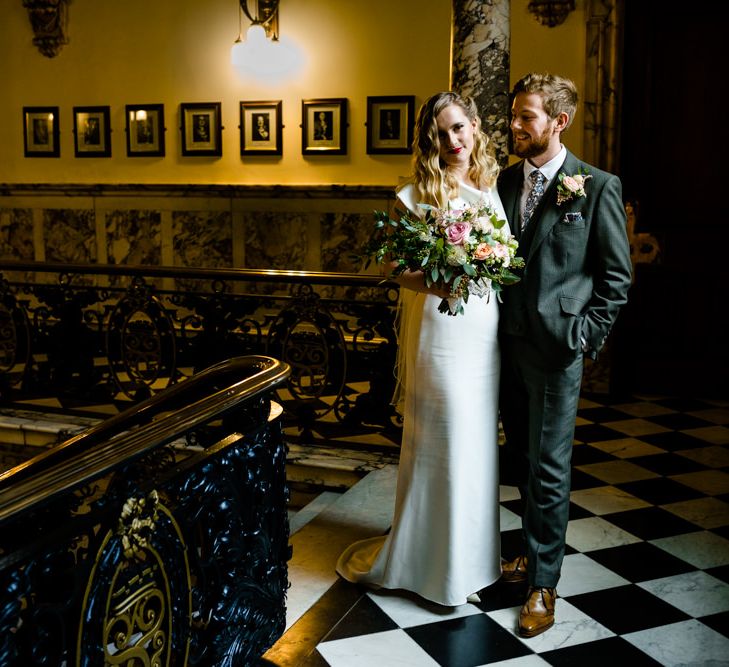 Bride in Vintage Wedding Dress and Groom in Tailored Suit