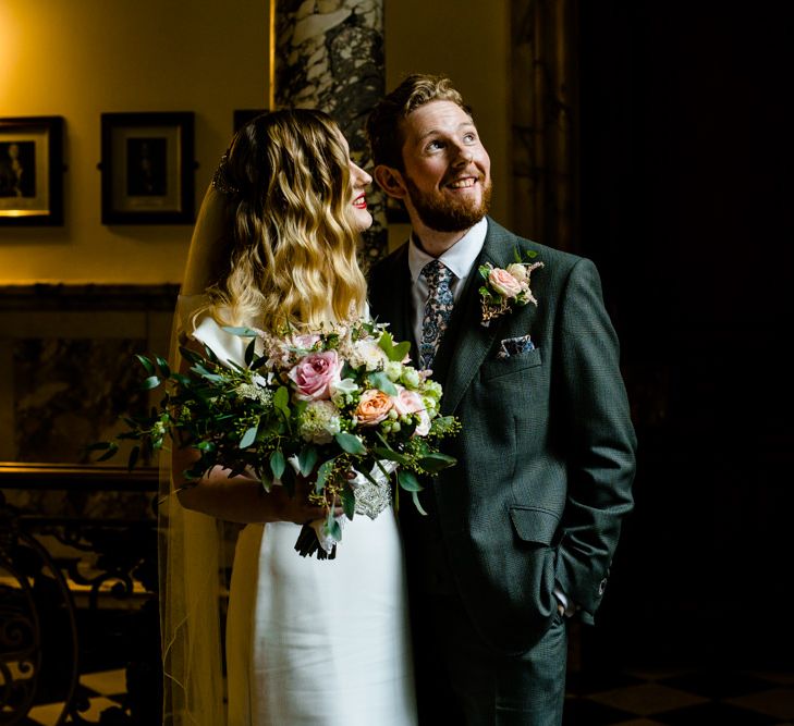 Bride in Satin Wedding Dress with Finger Waves and Groom in Tailored Suit