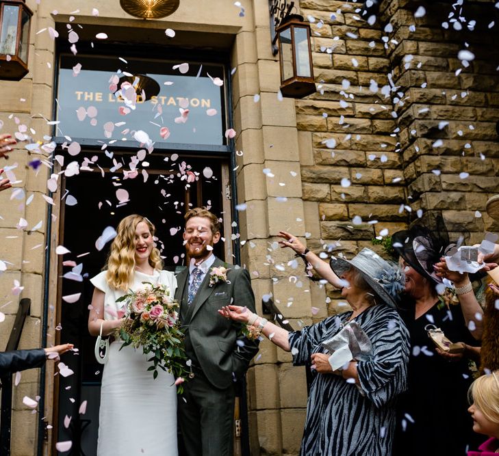 Confetti Moment with Bride in Vintage Wedding Dress and Groom in Tailored Suit