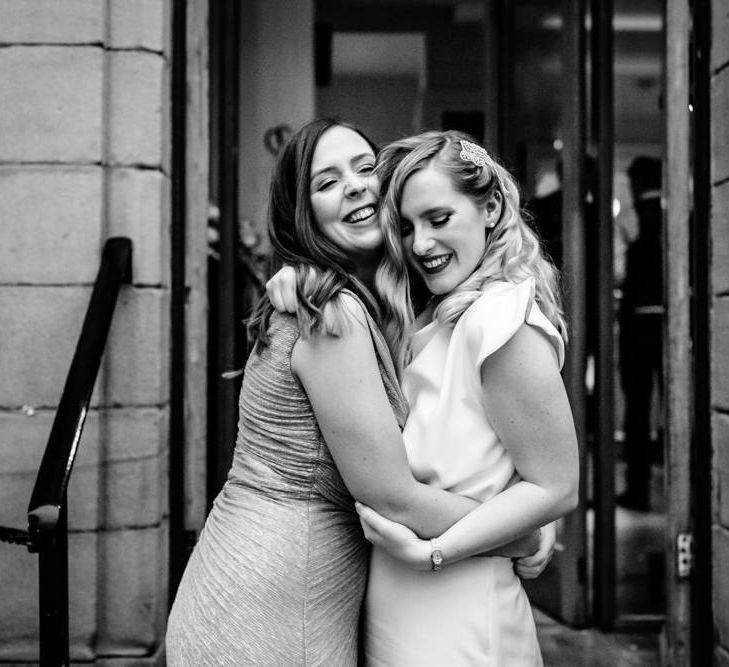 Vintage Bride in Satin Wedding Dress, Finger Waves and Red Lipstick Hugging Bestie