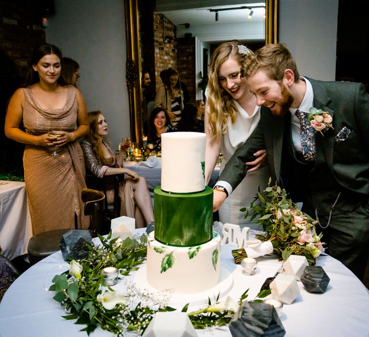 Bride and Groom Cutting Wedding Cake