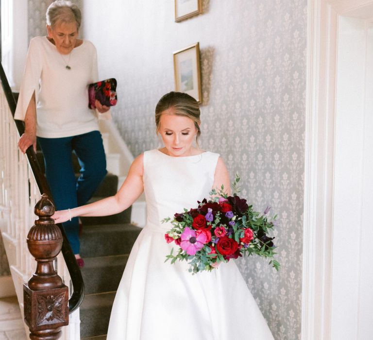 Jewell coloured bridal bouquet with tea-length bride dress