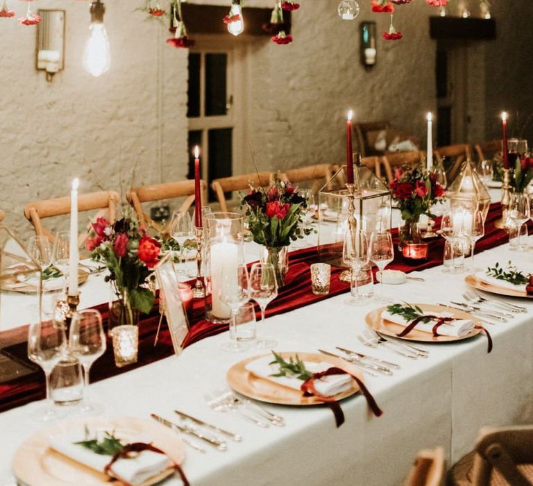 Table decor with candles and flowers at Christmas wedding