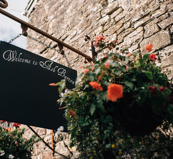 Hanging Wedding Venue Sign with Hanging Basket of Flowers