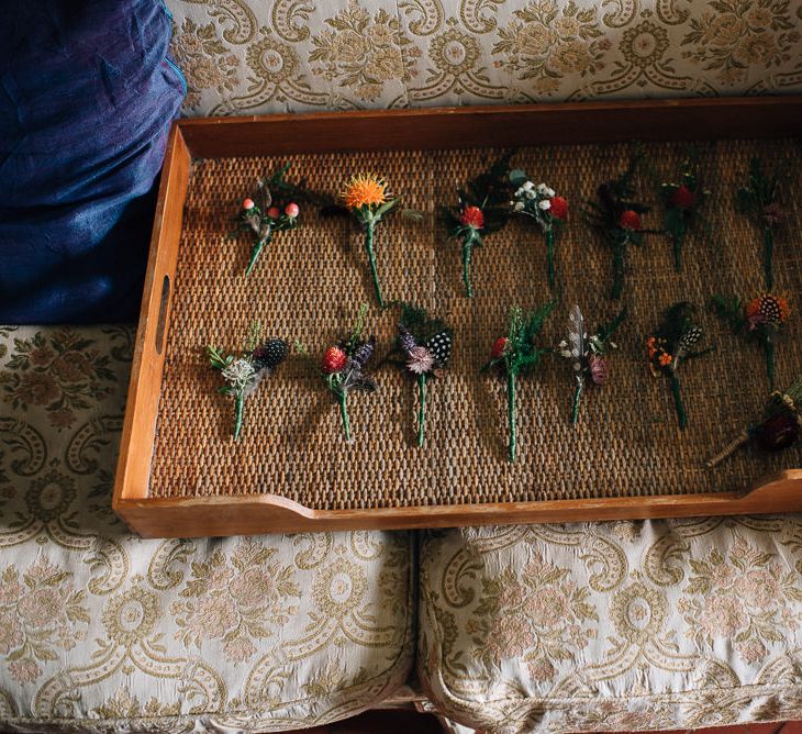 Tray of Unique Buttonholes with Feathers and Flower Stems