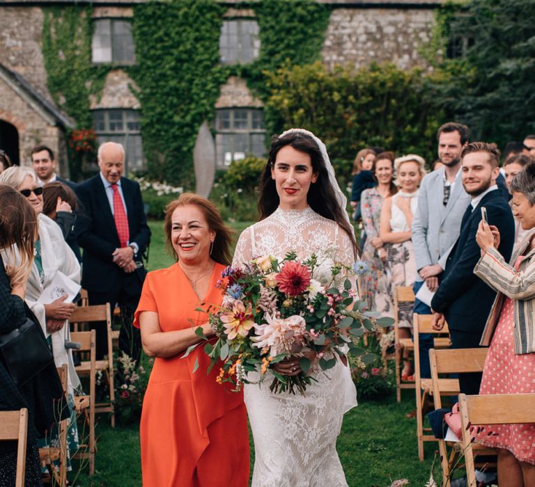 Outdoor Wedding Ceremony Bridal Entrance in Lace Catherine Deane Bridal Gown Escort by The Mother  of The Bride