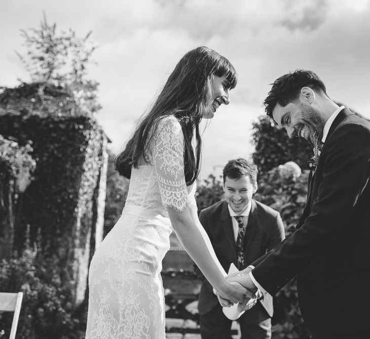 Bride and Groom Holding Hands and Laughing at their Persian Wedding