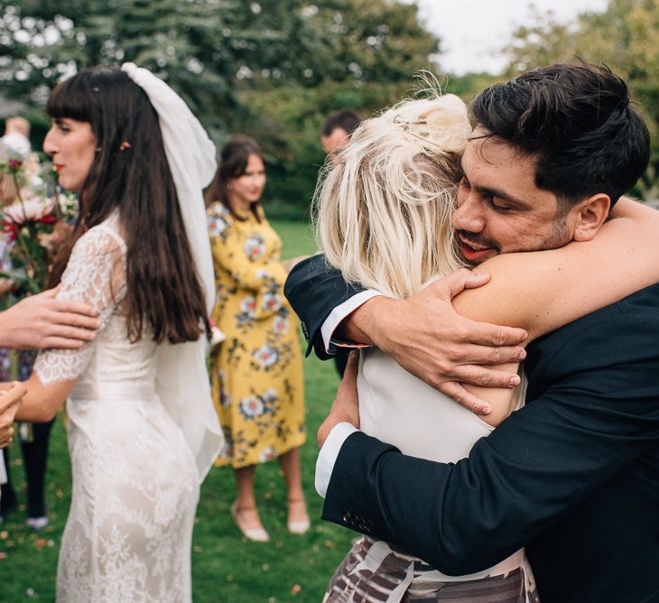 Bride and Groom Being Hugged by Wedding Guests after Just Getting Married