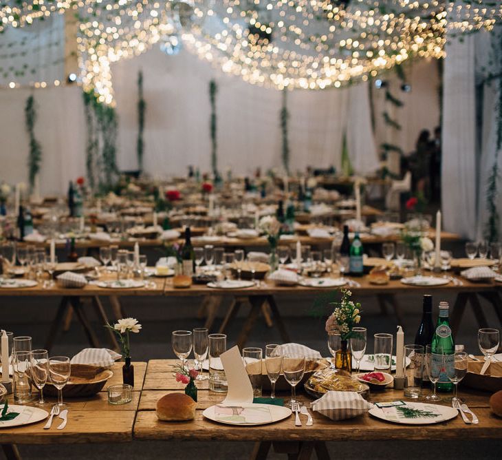 Rustic Wedding Reception with Trestle Tables and Fairy Lights Decor