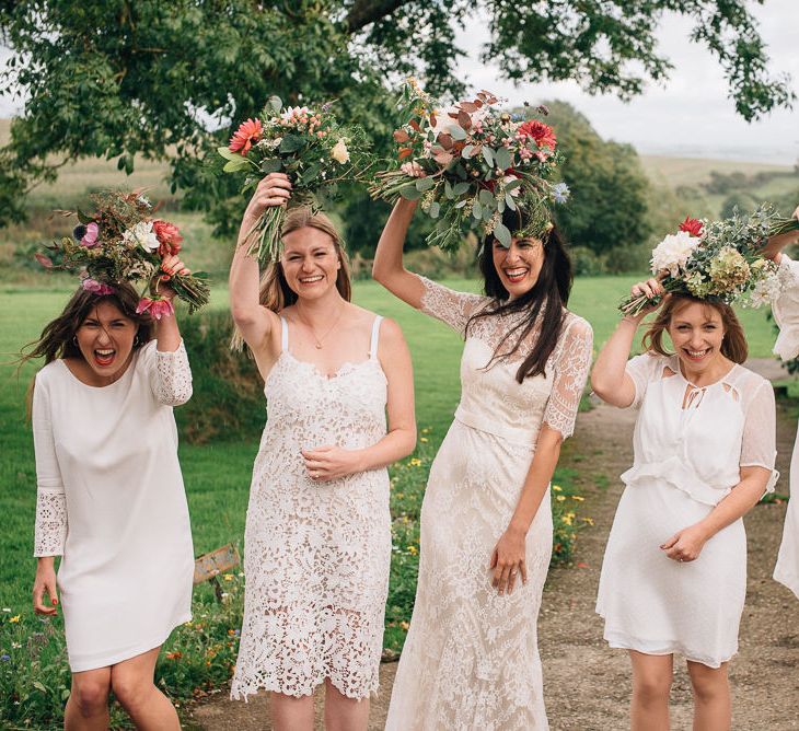 Bridal Party with Bride in Lace Catherine Deane Wedding Dress and Bridesmaids in Different White Dresses