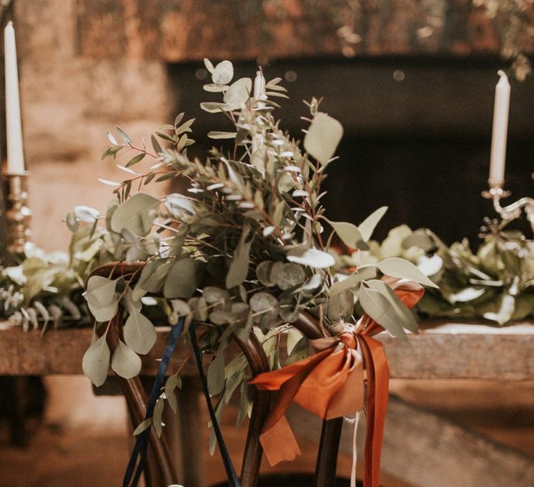 Mrs chair back wedding decor with foliage and ribbon