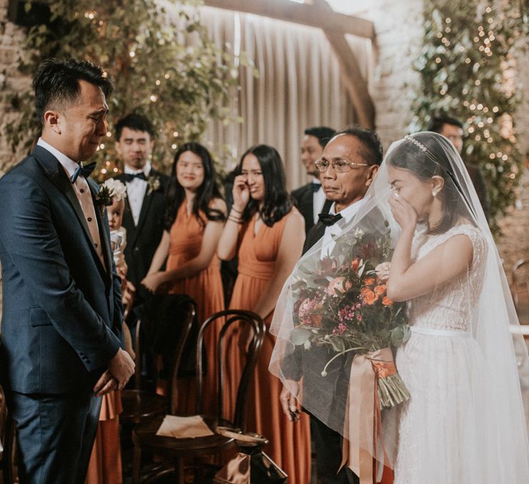 Emotional wedding ceremony bridal entrance at Cripps Barn