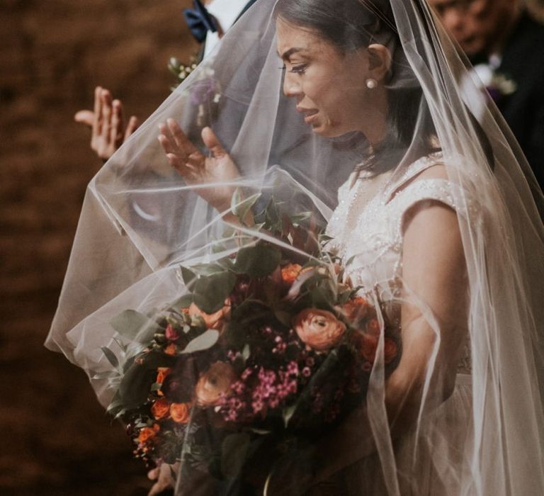 Emotional bride and groom during wedding blessing