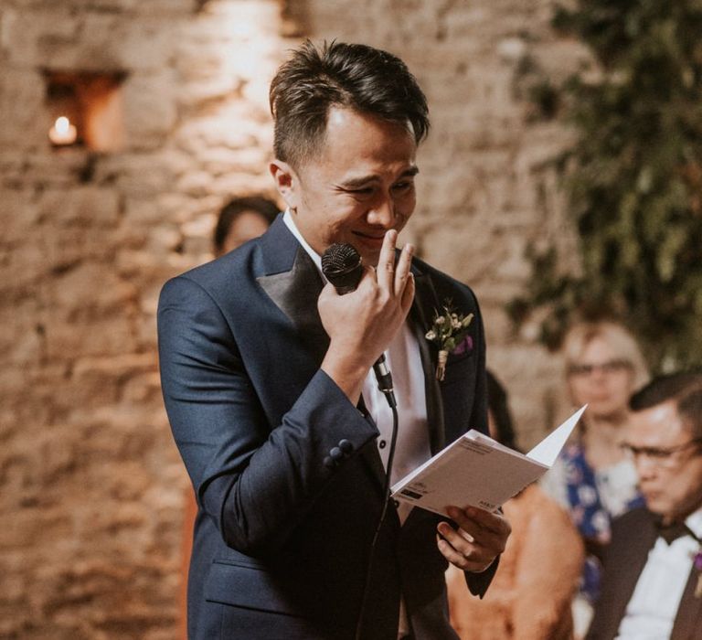 Emotional groom reading his vows during the wedding ceremony