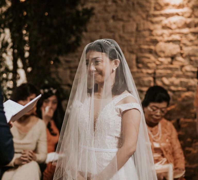 Bride with veil on during the wedding ceremony