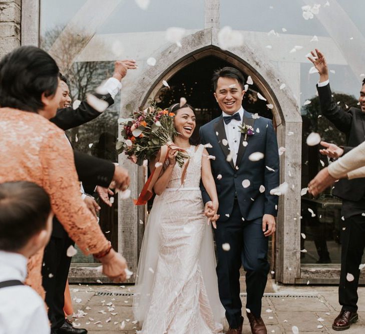 Bride and groom confetti exit at Cripps Barn