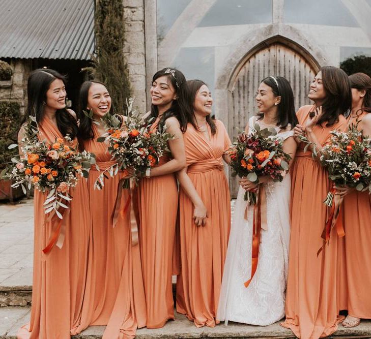 Bridal party portrait with bridesmaids in orange dresses for Autumn dresses