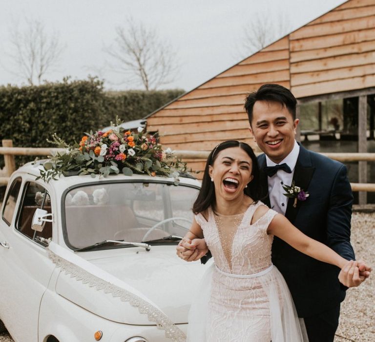 Happy bride and groom portrait by Nataly J Photography