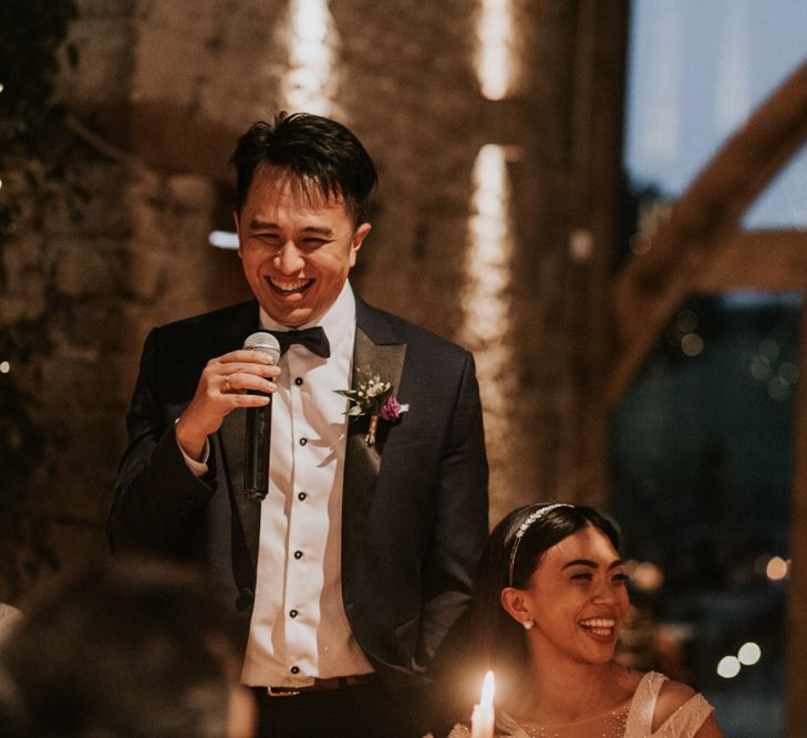 Groom giving a wedding speech at intimate wedding reception